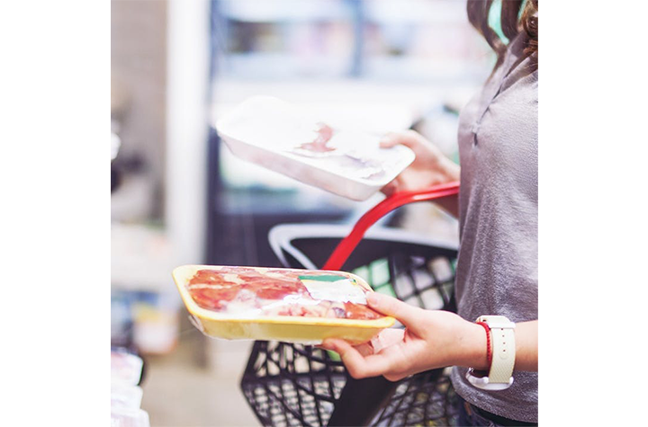 Woman looking at food safety label.