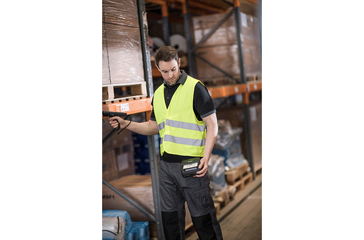 warehouse worker using Brother RuggedJet 4 mobile label barcode label printer